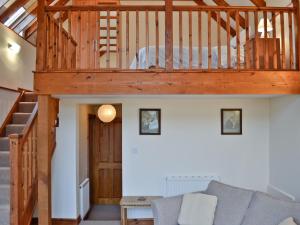 a living room with a loft with a bed at Taw in Great Torrington