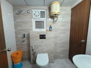 a bathroom with a toilet and a sink at The Himalayan Haven- Luxury 1 BHK Apartment in Rājpur