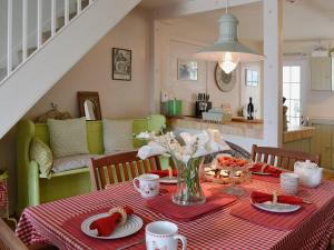 une salle à manger avec une table et un chiffon rouge dans l'établissement Seaside Stories, à Brixham