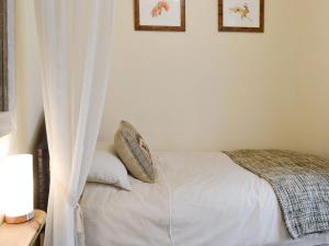 a bedroom with a bed and two pictures on the wall at Eldin Hall Cottage 1 - Uk2483 in Cayton