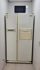 Elle comprend un réfrigérateur blanc et un four micro-ondes. dans l'établissement On the main street of HBC, à Séoul