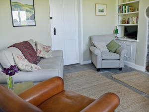 a living room with a couch and two chairs at Gardenwell Cottage in Hawes