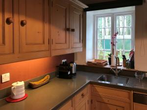 a kitchen counter with a sink and a window at Overwater Lodge in Bassenthwaite Lake