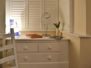 a dresser with a mirror on top of it at The Studio in Cuckfield