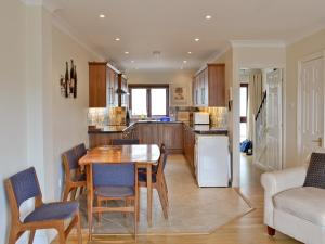 a kitchen and dining room with a table and chairs at Harbour View in Castletown