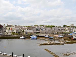 a group of boats docked in a river with houses at Harbour View in Castletown