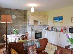 a kitchen and living room with a couch and a table at Quartermasters in Brancepeth