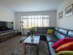 a living room with a couch and a table at Greenridge in Totland