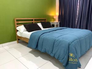 a bedroom with a bed with a blue blanket on it at Hud-Hud Homestay 2 Gelang Patah in Gelang Patah