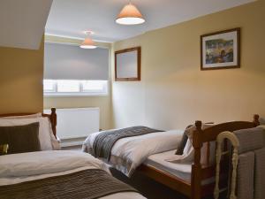 a bedroom with two beds and a window at Reedcutters in Reedham