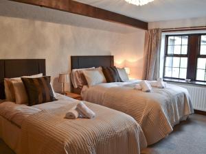 a bedroom with two beds with towels on them at The Old School in Durham