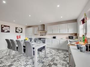 a kitchen with a table and chairs in a room at Graces Dairy in Wooler