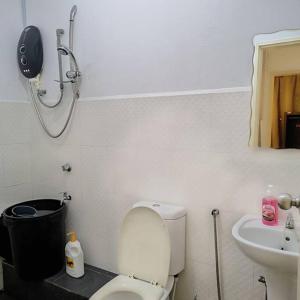 a bathroom with a toilet and a sink at Luxury UUC Homestay KKIP Telipok Kota Kinabalu in Kota Kinabalu