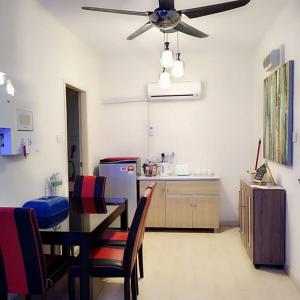 a kitchen with a dining table and a ceiling fan at Luxury UUC Homestay KKIP Telipok Kota Kinabalu in Kota Kinabalu