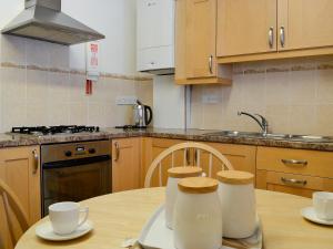 a kitchen with a table with two mugs on it at Inglewood - 15288 in Keswick