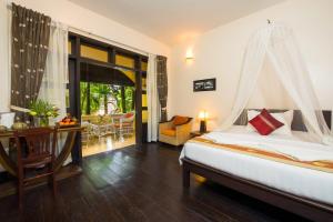 Postel nebo postele na pokoji v ubytování Marirath Boutique Hotel