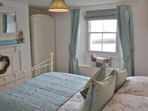 a bedroom with a bed and a window at Tranquility - 28004 in Mevagissey