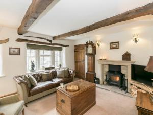 a living room with a couch and a fireplace at Narrowgates Cottage in Barrowford