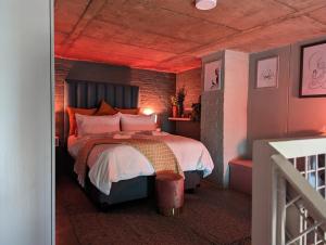 a bedroom with a bed with a red ceiling at The Artful Cityscape Loft - Serenity In The City in Johannesburg
