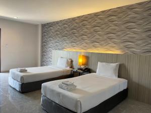 Postel nebo postele na pokoji v ubytování Embryo Hotel 