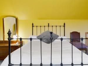 Schlafzimmer mit einem Bett mit weißer Bettwäsche und einem Spiegel in der Unterkunft Tigh-an-achaidh in Inverinate