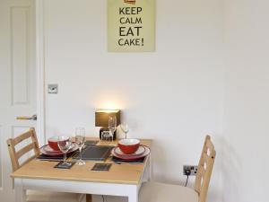 a table with wine glasses and a laptop on it at Bellwood House Annexe in Felixkirk