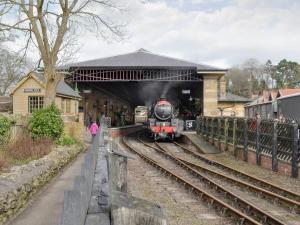 a steam train pulling into a train station at Bellwood House Annexe in Felixkirk