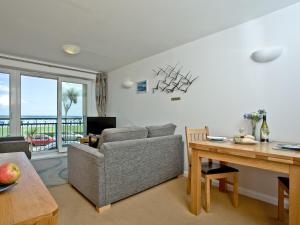 a living room with a couch and a table at 16 Belvedere Court in Paignton