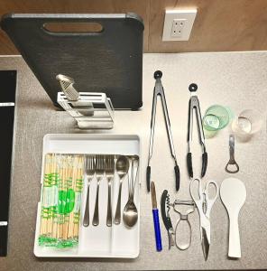 a table with utensils on a counter with a container at OH!TOMARI in Nanao