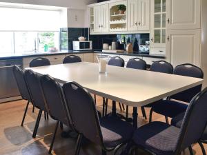 a kitchen with a table with chairs around it at The Farmhouse in Hampreston