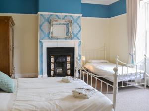 A bed or beds in a room at Blaithwaite House