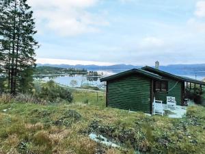 una piccola casa su una collina con vista sul lago di Holiday home LINDÅS III a Lindås