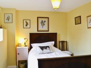 a bedroom with a bed with a dog pillow on it at Oldfield in Warminster