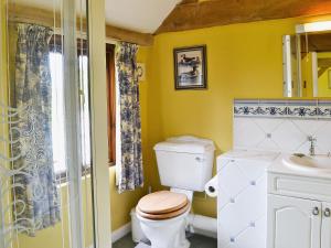 a bathroom with a toilet and a sink at Oldfield in Warminster