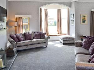 a living room with two couches and a window at South Cliff Sands Ii in Scarborough