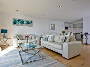 a living room with a couch and a table at 4 Ocean Point in Croyde