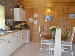 a kitchen with a table and chairs in a kitchen at Valley View Annex in Ringwood