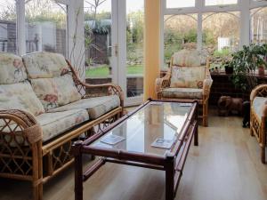 a living room with two chairs and a coffee table at 24 Steed Close in Goodrington
