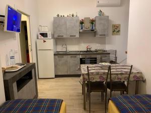 a kitchen with a table and chairs and a refrigerator at casa RosAlina in Verona