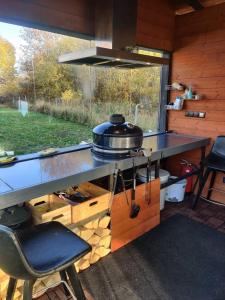 a kitchen with a table with a pot on top of it at Hurmioru guesthouse near Otepää with sauna in Hurmi