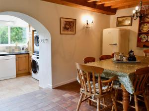 a kitchen with a table and a refrigerator at North Huckham in Exton