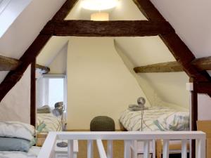 a room with two beds in a attic at Lamont Cottage in Niton