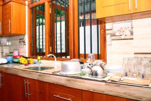 a kitchen with a sink and a counter with glasses at Hispaniola villa in Mirissa