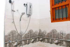 a shower in a wall with a picture of trees at Hispaniola villa in Mirissa