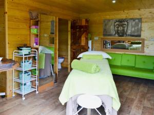a room with two beds in a log cabin at Byre Cottage - 29410 in Elmsted