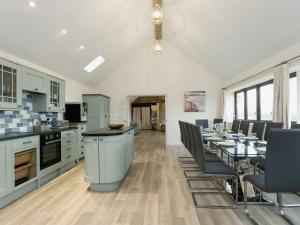a kitchen and dining room with a table and chairs at Longview in Stanton Saint Quintin