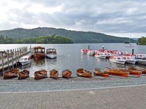 a bunch of boats are docked at a dock at Strawberries And Cream in Bowness-on-Windermere