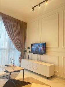 a living room with a flat screen tv on a wall at Rizz Residence Troika KB in Kota Bharu