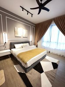 a bedroom with a bed and a ceiling fan at Rizz Residence Troika KB in Kota Bharu