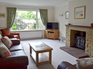 a living room with a couch and a fireplace at Fairfield in Barrowford